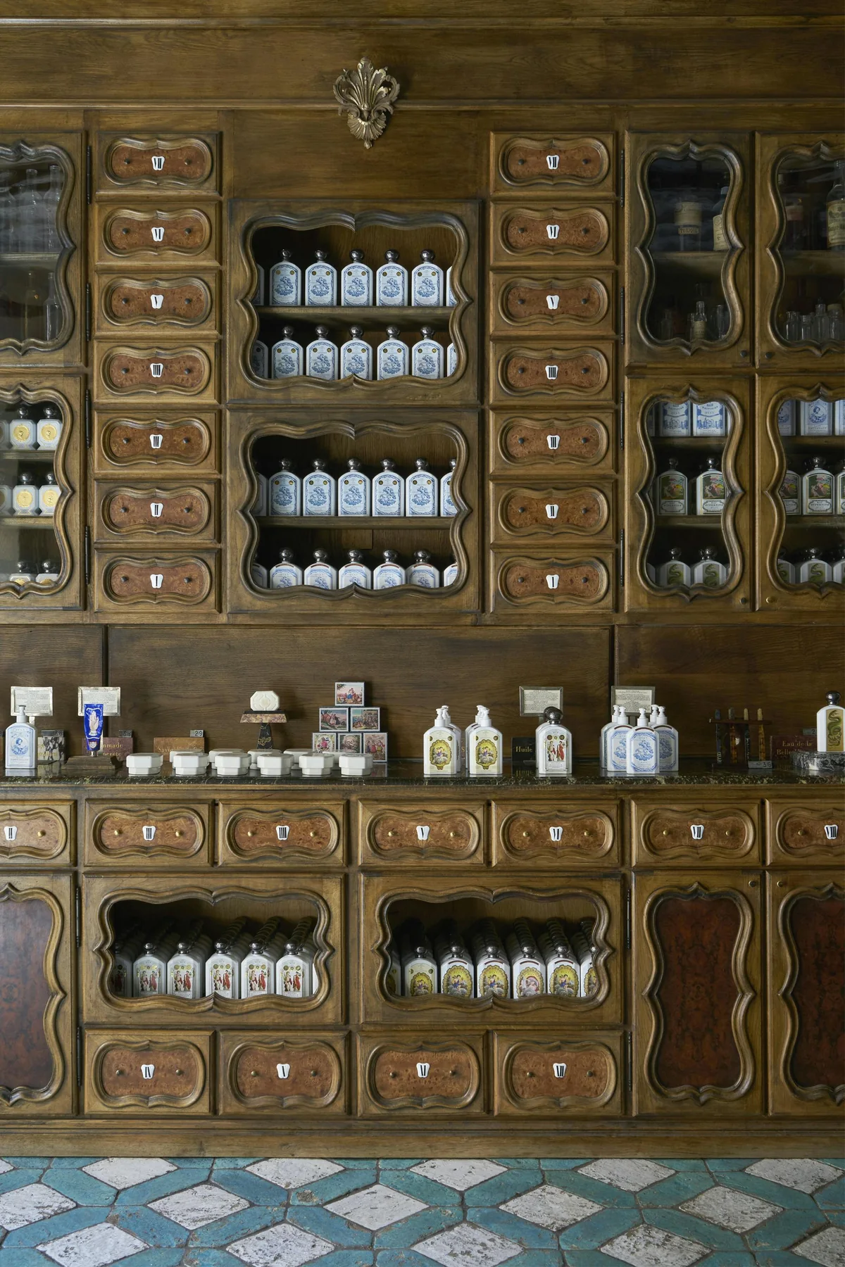 Officine Universelle Buly store with dark wooden apothecary cabinets